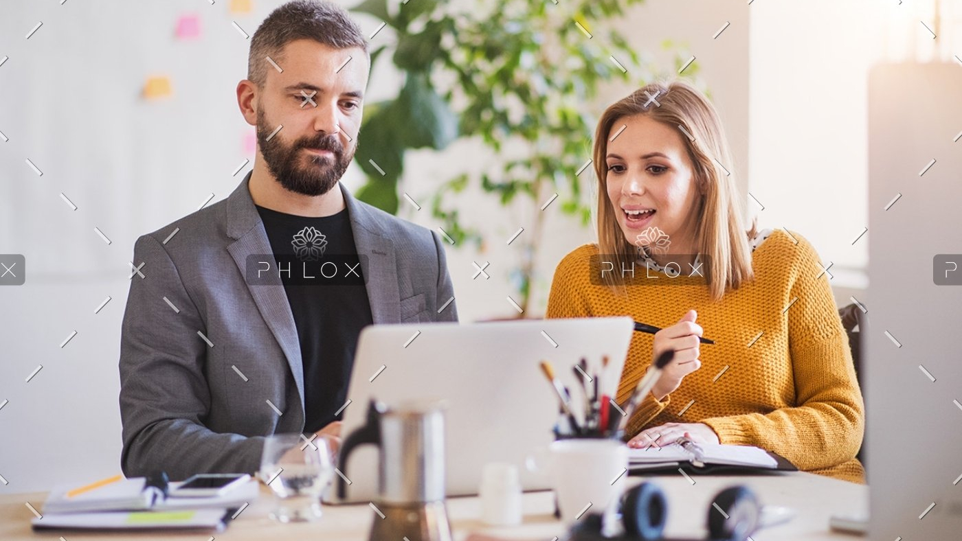 two-business-people-with-wheelchair-in-the-office-P7XLSBC-1