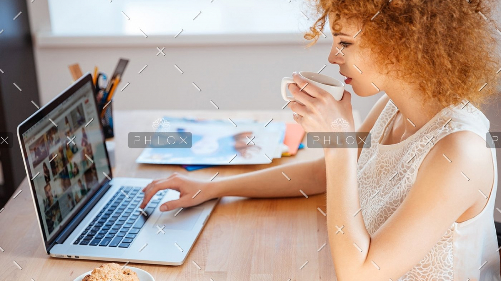 woman-photographer-drinking-coffee-and-working-PJNBP6U-1